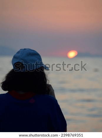The young woman looking the sea .So dramatic photo. Very good