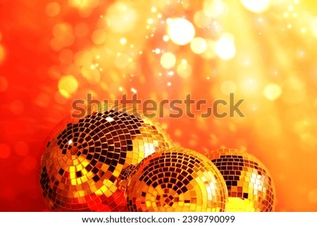 Shiny disco balls under golden lights, bokeh effect