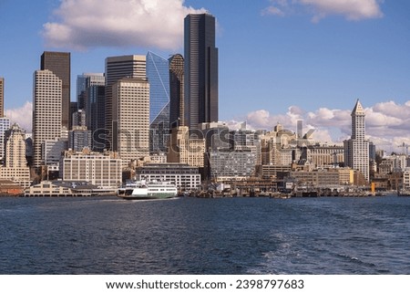 SEATTLE SKYLINE WITH COLUMBIA TOWER SMITH TOWER AND OTHER OFFICE BUILDINGS DOWNTOWN WITH A WASHINGTON STATE FERRY AND ELLIOTT BAY