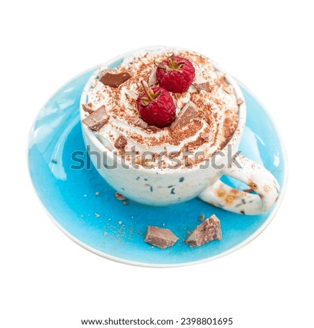 A beautiful blue cup of coffee with whipped cream, cocoa powder and raspberries on rustic wooden background
