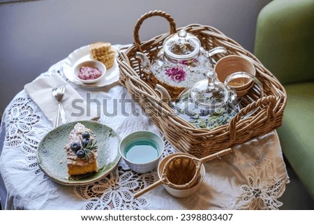 Afternoon Tea with cake, Table set for tea time. Royalty-Free Stock Photo #2398803407