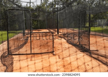 Batting cages on a baseball field with net.                               Royalty-Free Stock Photo #2398824095