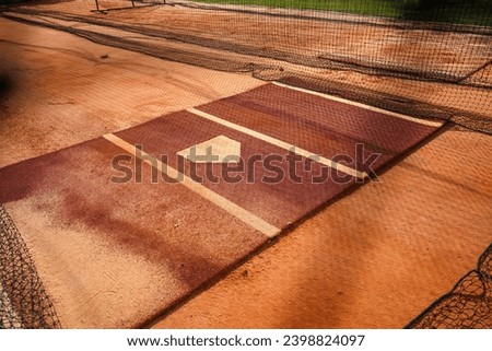 Batting cages on a baseball field with net.                               Royalty-Free Stock Photo #2398824097