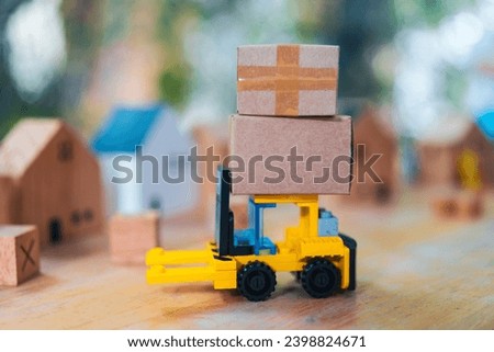 Delivery toy truck with brown package box. Online delivery service concept. A stack of parcels. A delivery vehicle arrives.