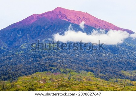 Mount Kerinci (Gunung Kerinci) is the highest mountain in Sumatra, the highest volcano and the highest peak in Indonesia with an altitude of 3805 masl, located in the Kerinci Seblat National Park area Royalty-Free Stock Photo #2398827647