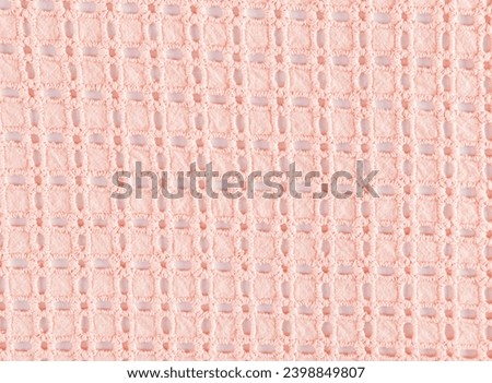 Beautiful lace cotton fabric in peach color. Layout for design. Abstract cotton texture background. The color of the year is peach fuzz
