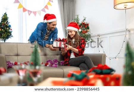Excited asian woman getting surprise gift from her girlfriend at home. Gives a Christmas gift, birthday gift, New year day celebration and congratulation