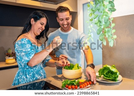 Newlywed couple preparing healthy food at home in a new kitchen