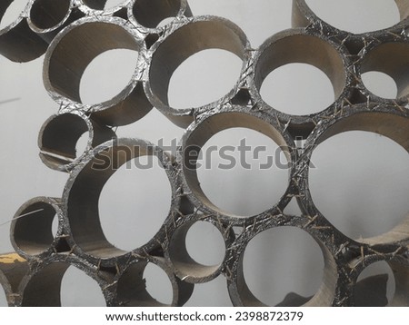 Modern interior design of dining room or workplace with arranged enameled plate. Hanging metal ornament texture on white wall background.