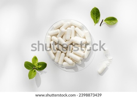 White capsules with minerals or food additives with an organic composition. Vitamins. 