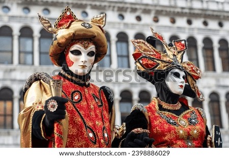  The masked couple in San Marco in Venice for the days of Mardi gras and the Carnival Royalty-Free Stock Photo #2398886029
