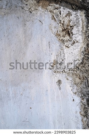 Cement concrete walls that are starting to wear out with faded paint
