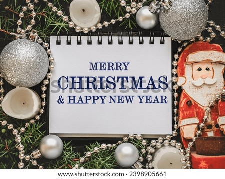 Merry Christmas. Happy New Year. Congratulatory inscription and Christmas decorations lying on an empty table. Close-up, view from above. Congratulations for loved ones, relatives, friends, colleagues