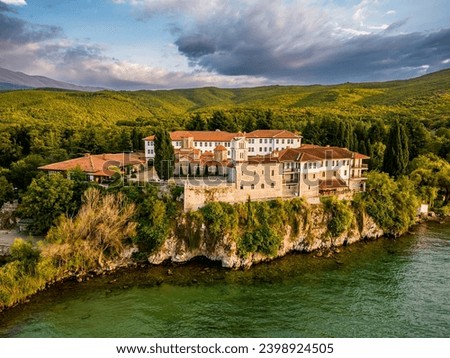Drone shot of Monastery of Saint Naum in very south of North Macedonia, standing on a cliff upon beautiful Ohrid Lake. Late summer sunset photo.