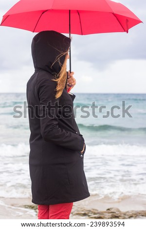 Woman with umbrella on beach 