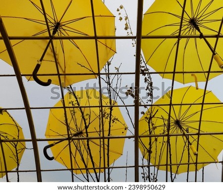 a model of a yellow umbrella hanging in the air