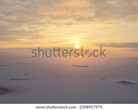 Snow and ice on Finnish bay at sunset