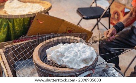 Picture of traditional Thai desserts It's called Khanom Khao Pong, made from milling rice into flour. Then roll it into a sheet. Then grilled over a charcoal fire. Makes the dessert puffy and crispy.