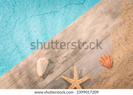 Shells on a wooden background above a swimming pool, with a blank space to write a message. Summer vacation atmosphere.