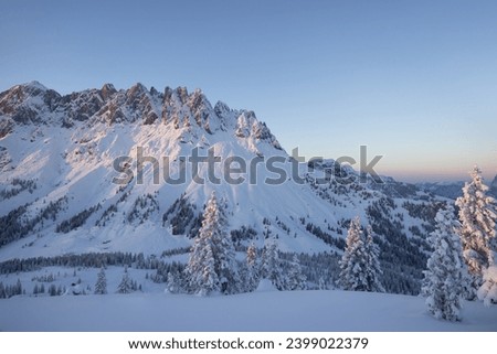 Golden light on the mountain range and a cold wilderness foreground