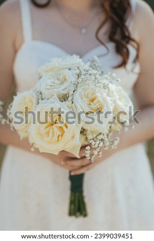 Bridal portrait in hands of a young girl in white dress, happy wedding day. 