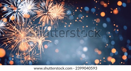 Gold and blue Fireworks and bokeh in New Year eve and copy space. Abstract background holiday. Royalty-Free Stock Photo #2399040593