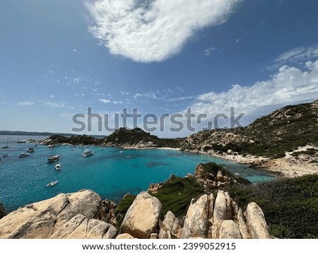 Beautiful view on a small cove called Cala Corsara in La Maddalena, Sardinia, Italy. The photo in taken from a hill and shows clear, blue water surrounded by white rocks and mediterranean vegetation