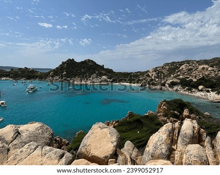 Beautiful view on a small cove called Cala Corsara in La Maddalena, Sardinia, Italy. The photo in taken from a hill and shows clear, blue water surrounded by white rocks and mediterranean vegetation
