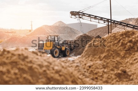 Yellow Excavator working on sand industrial quarry. Construction site industry banner concept.