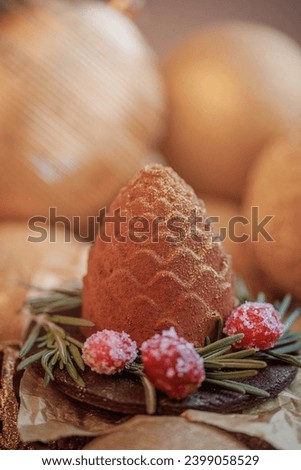 Christmas sweets cupcake chocolate cone on wooden background with gold pine tree with bokeh light, New Year sign for card.