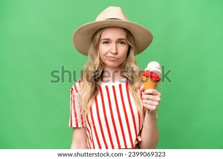 Young English woman with a cornet ice cream over isolated background with sad expression