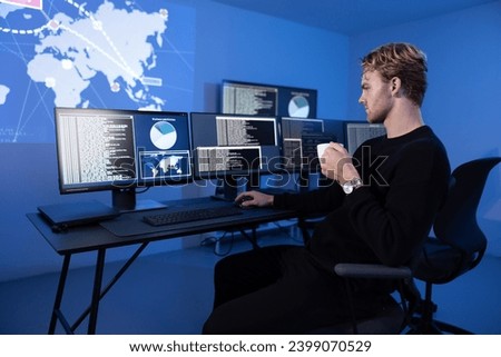 Back View in the Cyber Security Control Center Operator Working. Multiple Screens Showing Technical Data and Alerts. Royalty-Free Stock Photo #2399070529