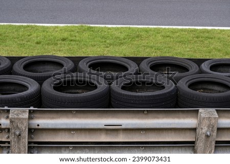 Race Track Tyre Wall - Crash Barrier lined with Used Tires at Racing Circuit Royalty-Free Stock Photo #2399073431