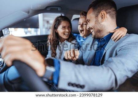Happy family choosing new car, salesman showing them luxury auto at automobile dealership store. Customers selecting vehicle, consulting manager at modern showroom shop Royalty-Free Stock Photo #2399078129