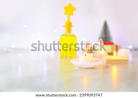 Christmas table with candles decor. A light table with stars and bokeh.