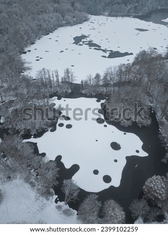 Drone shot of a lake covered with snow