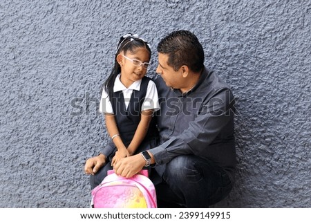 Divorced single dad goes to pick up his 4-year-old daughter in uniform from school, dark-skinned Latinos talk to prevent abuse and violence Royalty-Free Stock Photo #2399149915