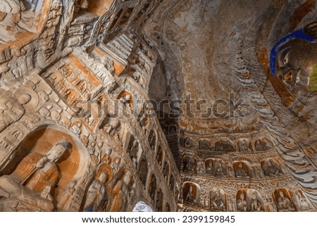Inside the Yungang Grottoes. World cultural heritage. One of China's four most famous Buddhist Caves Art Treasure Houses, is located Datong, Shanxi Province. It is cave 20. Buddha is 13.7 metres high. Royalty-Free Stock Photo #2399159845