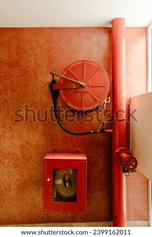 Fire extinguisher and fire hose reel in the condo corridor.