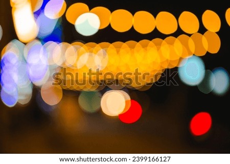 Yellow, orange, blue, red, green market lights bokeh in the early evening