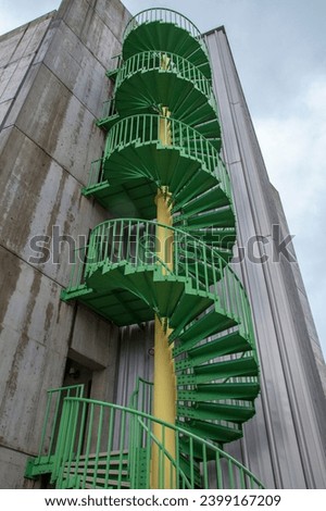 green spiral staircase at the side of the building.