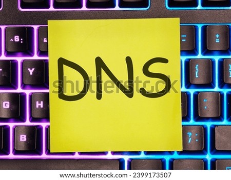DNS -Domain Name Server written on a yellow sticker on a laptop keyboard with backlight