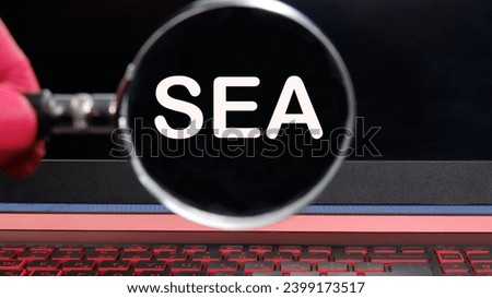 SEA text on the monitor found through a magnifying glass