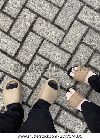 Photo of both feet wearing brown footwear