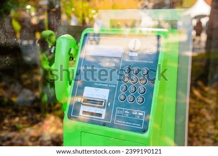 Public phone booth in Japan, green color pay phone with braille for the blind. Royalty-Free Stock Photo #2399190121