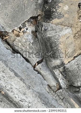 a crack in the concrete wall of a building in the city of london.