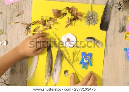 Autumn crafts. Child making crafts from natural dry plants, flowers, grass and leaves use  plasticine. Back to school, natural history. Ideas for children's art