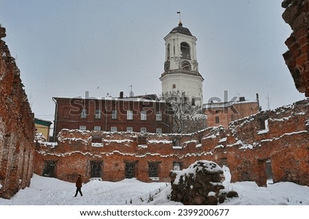 Old town ruins with the Clock Tower in Vyborg in winter, Leningrad region of Russia Royalty-Free Stock Photo #2399200677