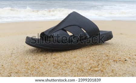 this is a picture of flip flops with  a beach back ground