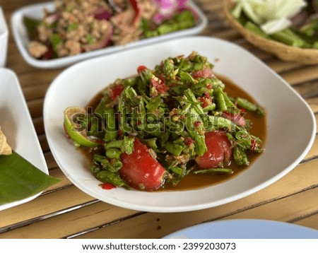 Spicy Long Beans Salad. Hot spicy lentils salad Thai tradition food with herby ingredient. Food menu thai Long Bean Salad Recipe  - northeast thai food. Royalty-Free Stock Photo #2399203073